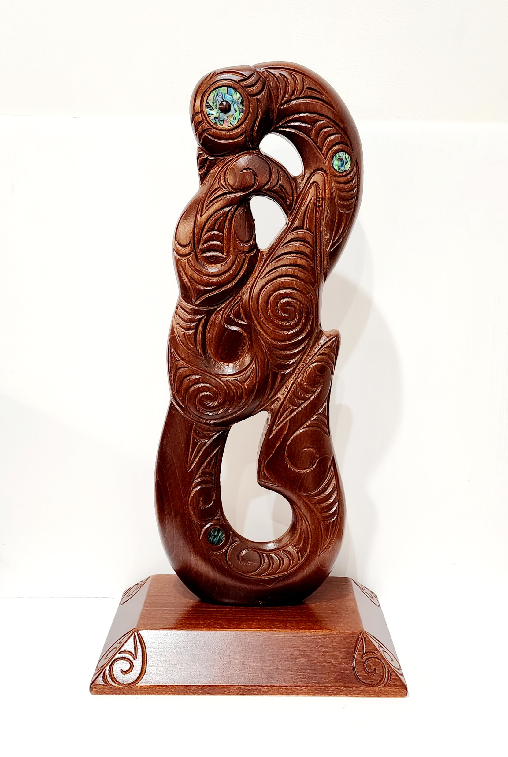 Large Carved Maori Hei Matau (Fish Hook) from Kauri Wood with Paua Shell Eyes on Stand 21st Keys 