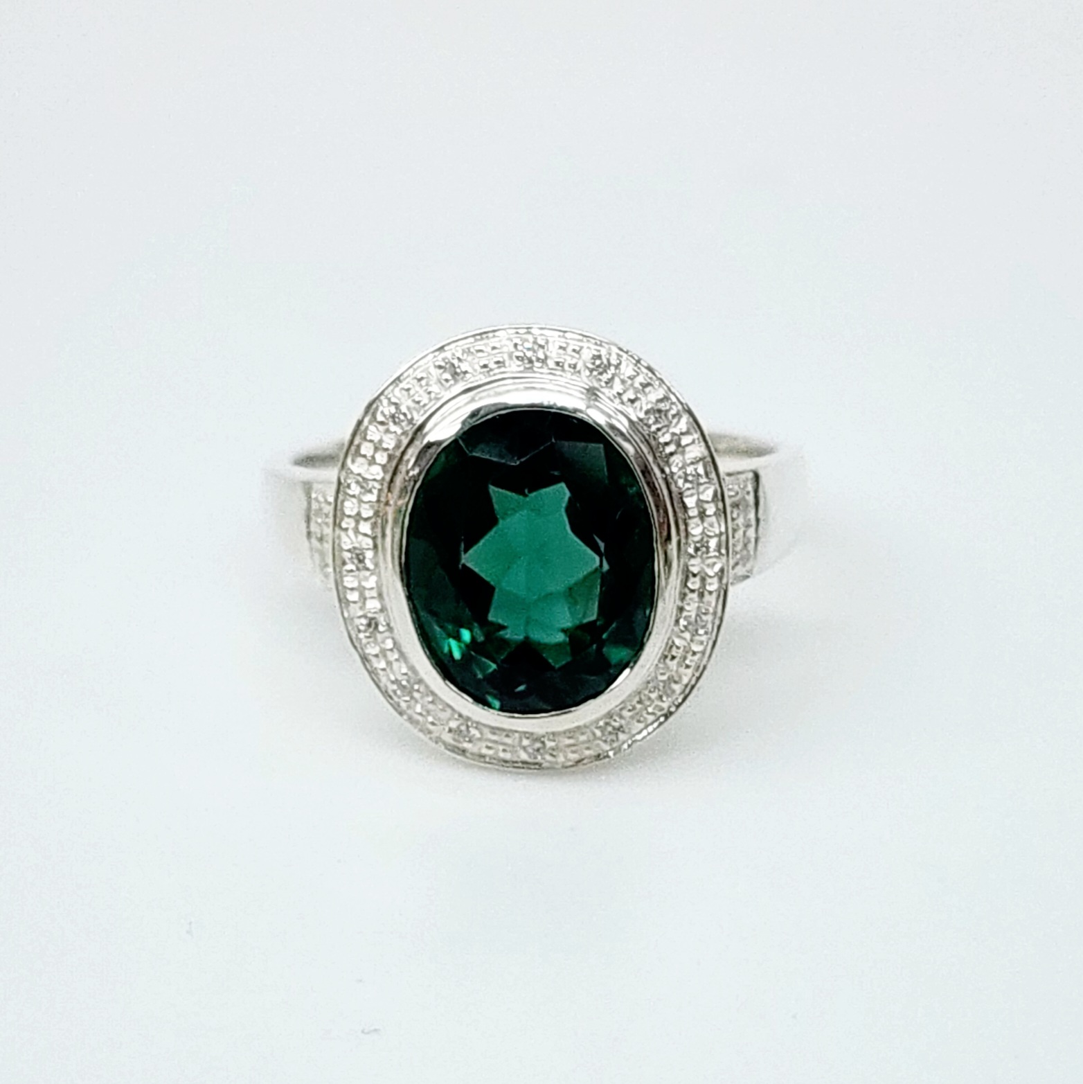 Sterling Silver 10mm x 13mm Ocal Cut Bezel Set Green CZ and Halo CZ Setting Ladies Dress Ring Sterling Silver Rings Sterling Silver 10mm x 13mm Ocal Cut Bezel Set Green CZ and Halo CZ Setting Ladies Dress Ring Sterling Silver Rings