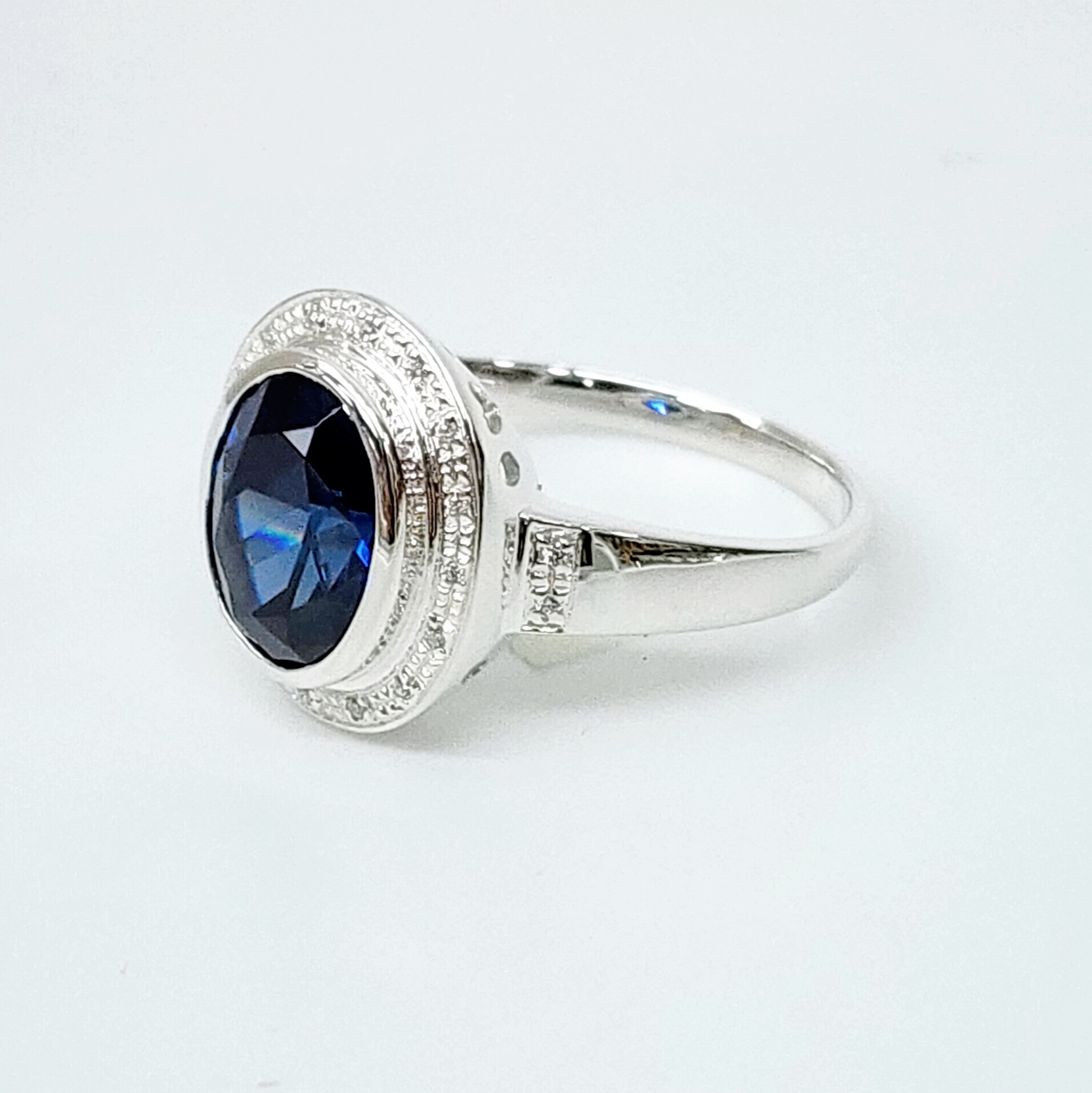 Sterling Silver 10mm x 13mm Ocal Cut Bezel Set Blue CZ and Halo CZ Setting Ladies Dress Ring Sterling Silver Rings 