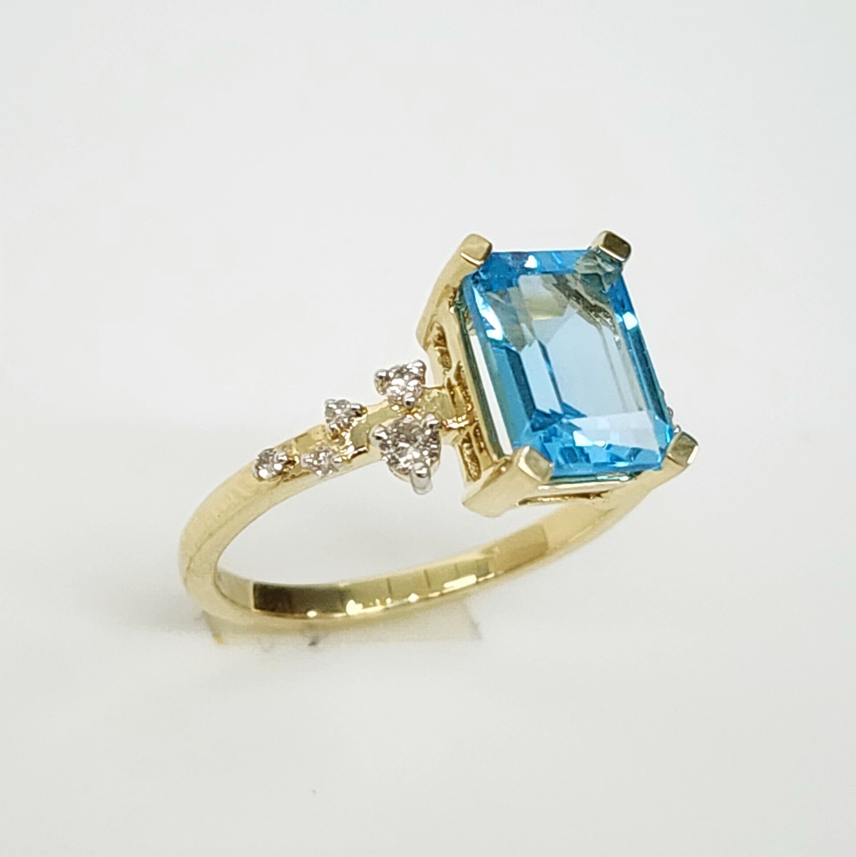 10ct Yellow Gold 0.15ct Diamond & 2.40ct Emerald Cut Blue Topaz Ring - SKR41115BT Gold Rings 10ct Yellow Gold 0.15ct Diamond & 2.40ct Emerald Cut Blue Topaz Ring - SKR41115BT Gold Rings